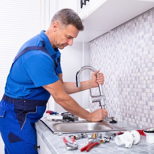 plumber repairing a faucet