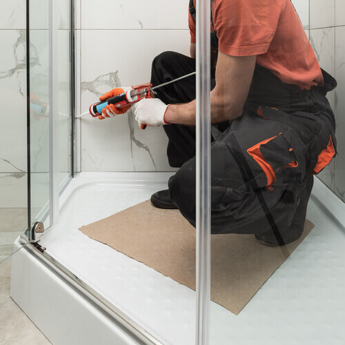 close-up of a plumber installing a shower