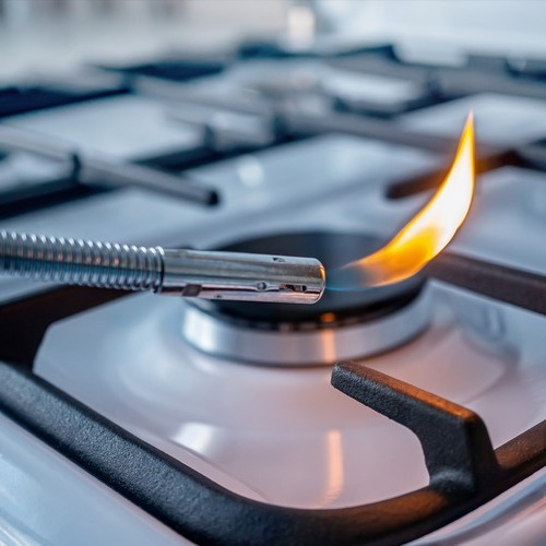 close-up of a gas stove burner being lit