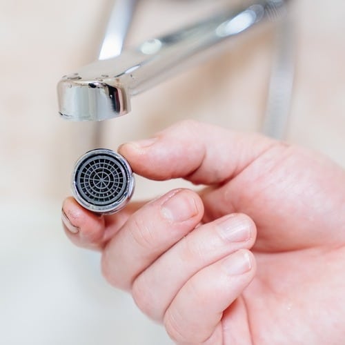 close-up of a faucet being repaired