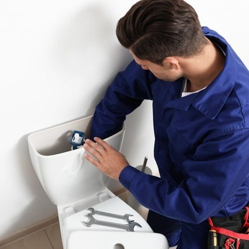 plumber providing toilet repair