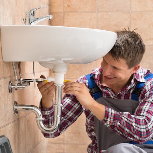 plumber repairing a bathroom sink