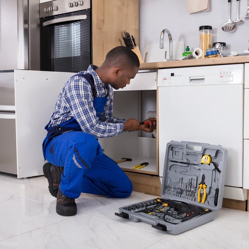 plumber working underneath a sink