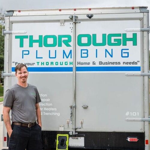 plumber standing outside the Thorough Plumbing truck